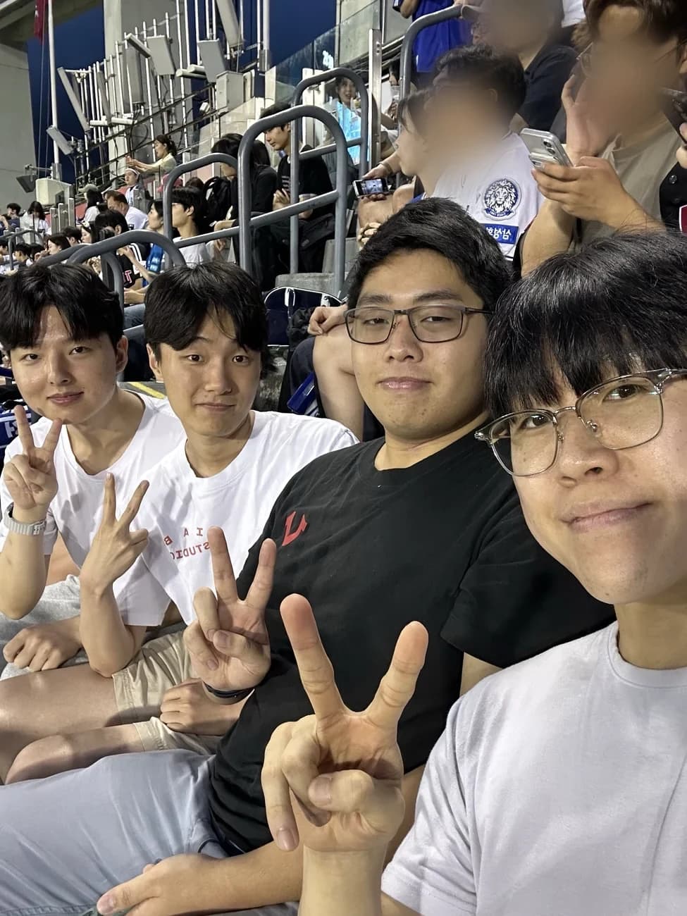 Guests and buddies smiling together in the baseball stands