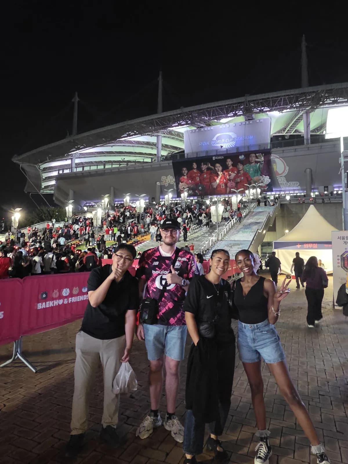 Guests and their tour guide buddy outside Seoul World Cup Stadium after a Korea national team match