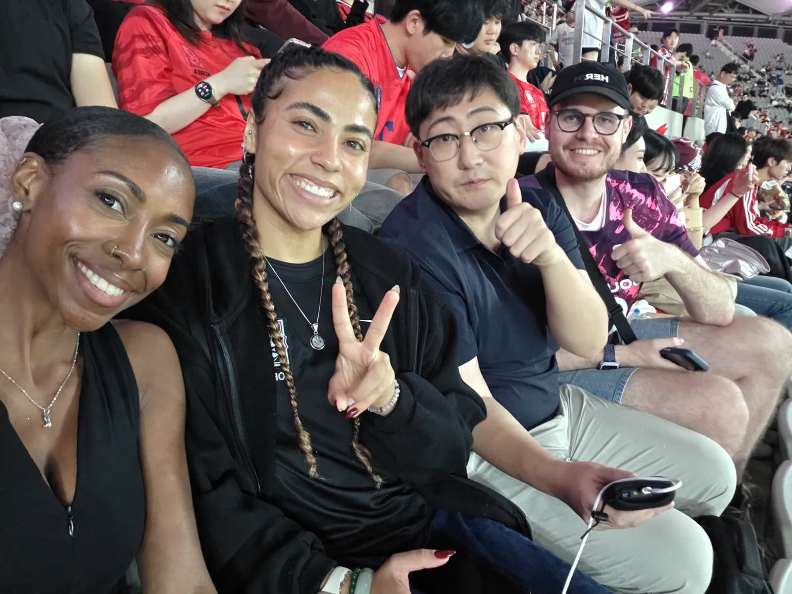 Guests and their tour guide buddy in the stands at a Korea national team match
