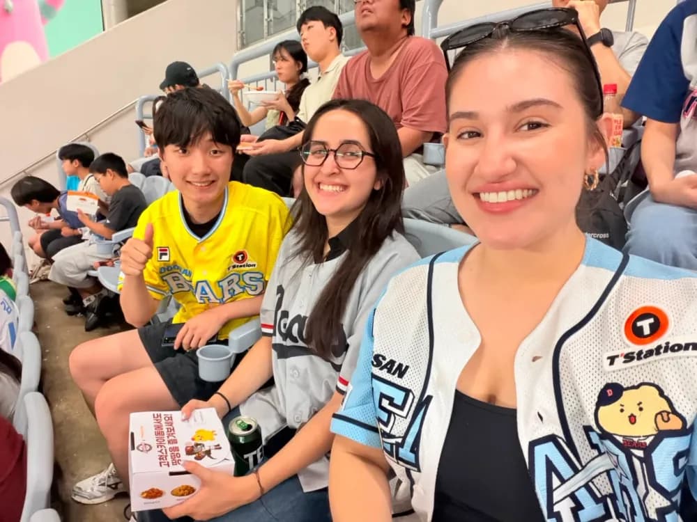 Guests and a buddy sharing snacks in the stands at Gocheok Sky Dome